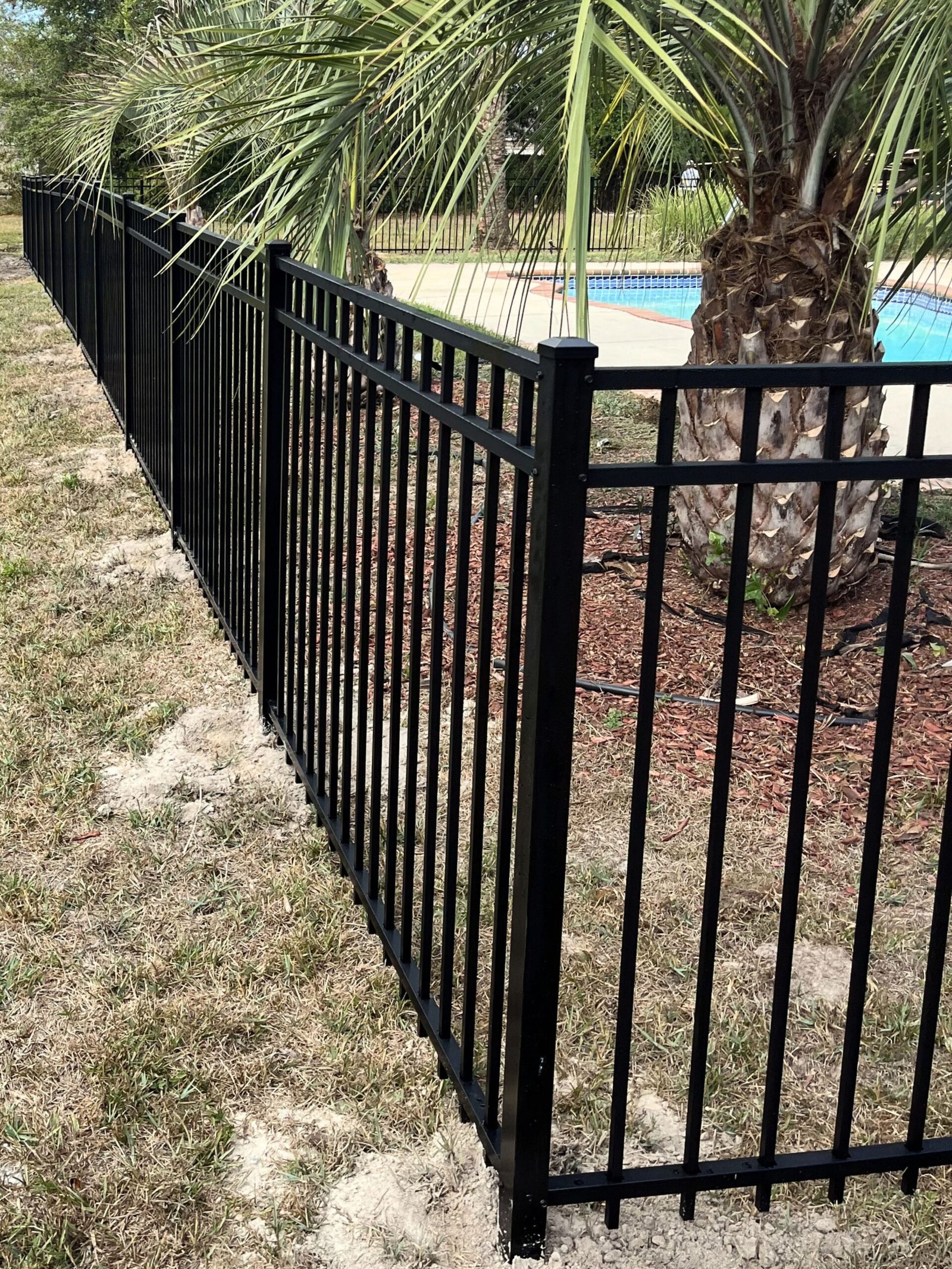 Black aluminum pool fence installation in Ocean Springs